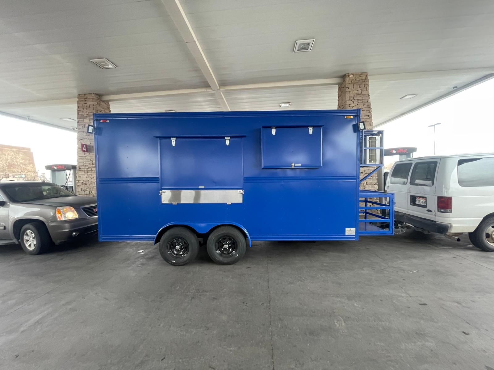 a blue trailer in a parking lot